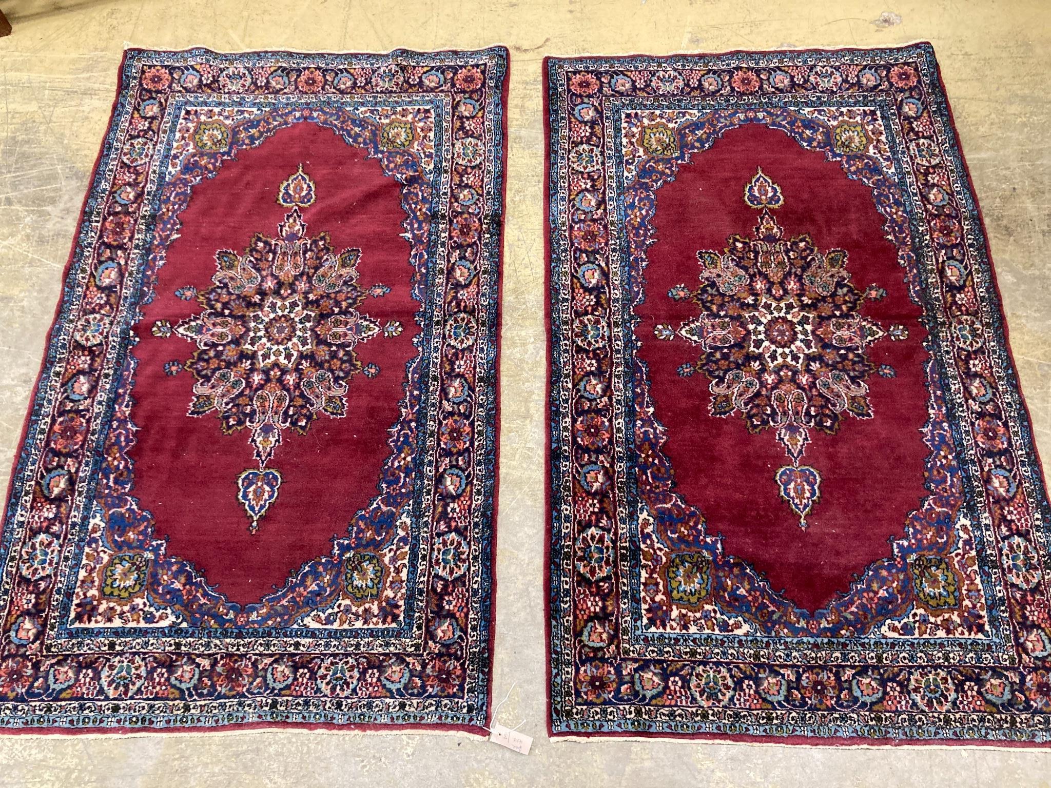 A pair of North West Persian burgundy ground rugs, 160 x 98cm